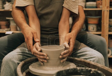 Photo for Couple mold ceramic vase in a pottery workshop, hands close up. The concept of hobbies, lifestyle and relationships. - Royalty Free Image