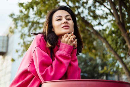 Foto de Beautiful stylish Asian young woman in pink sweatshirt, outdoor portrait, summer time. - Imagen libre de derechos