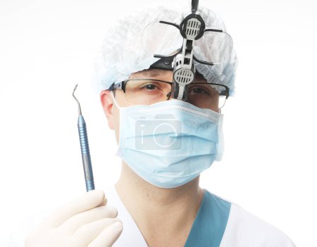 Photo for Dentist man holding tools isolated on white background, xlose up portrait - Royalty Free Image