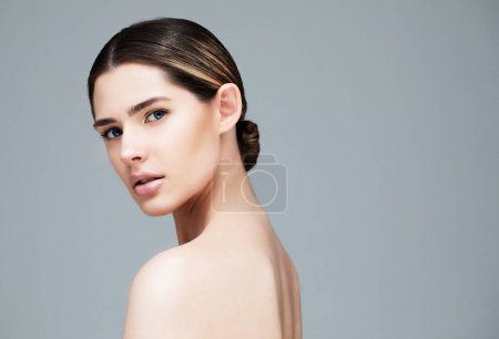 Photo for Closeup portrait of a face of the young attractive female with a healthy skin on grey background. Beauty and people concept. - Royalty Free Image