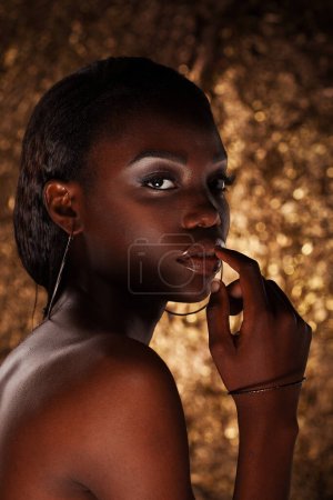 Photo for Close up portrait of sensual young african woman against gold background - Royalty Free Image