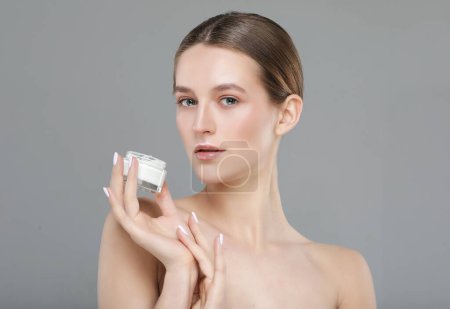 Téléchargez les photos : Soins de la peau- Jeune jolie femme tenant la crème cosmétique, photo rapprochée - en image libre de droit