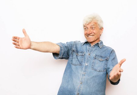 Photo for Lifestyle, emotion and old people concept. Happy old man show something over white background - Royalty Free Image