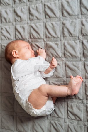 Photo for Little baby lying on a bed while sleeping - Royalty Free Image