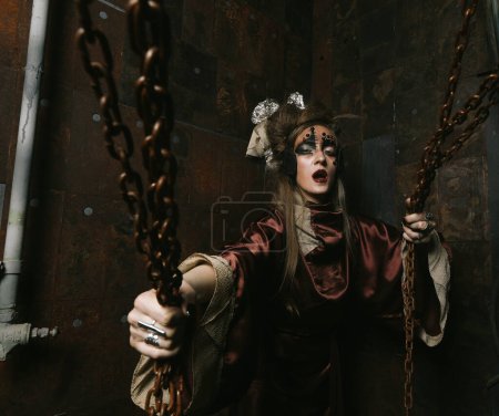 Aggressive stylish steampunk woman in a creative interior. Halloween theme.