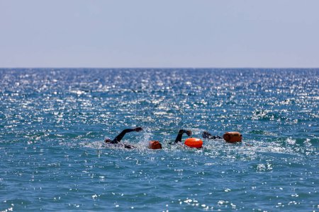 Photo for Swimmers training on the open sea / ocean. - Royalty Free Image
