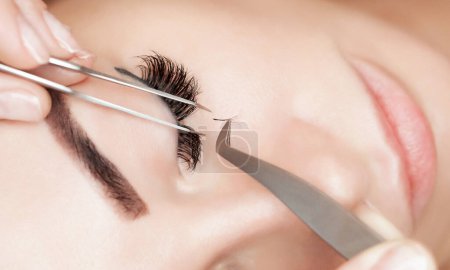 Photo for Eyelash removal procedure close up. Beautiful Woman with long lashes in a beauty salon. Eyelash extension. - Royalty Free Image