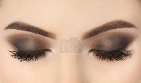 Photo for Beautiful woman with long eyelashes and with beautiful evening make-up. Closed eyes close up. - Royalty Free Image