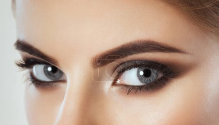 Photo for Beautiful Woman with long lashes and beautiful make-up looking at the camera. - Royalty Free Image