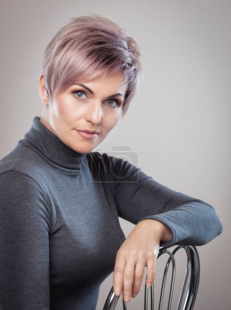 Photo for Portrait of a beautiful blonde woman with beautiful make-up and short haircut after dyeing hair in a hairdressing salon. - Royalty Free Image