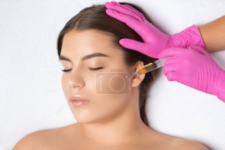 Kosmetikerin macht Prp-Therapie auf dem Gesicht einer schönen Frau in einem Schönheitssalon. Weibliche ästhetische Kosmetik im Schönheitssalon.