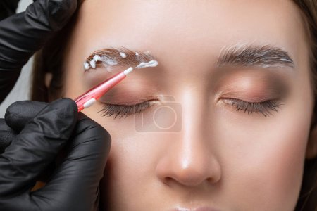 The make-up artist does Long-lasting styling of the eyebrows and will color the eyebrows. Eyebrow lamination. Professional make-up and face care.