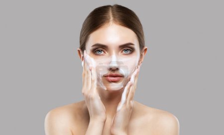 Une jeune belle fille se lave le visage avec de la mousse faciale. Soins du visage, traitement de la peau problématique, produits de soins quotidiens de la peau.