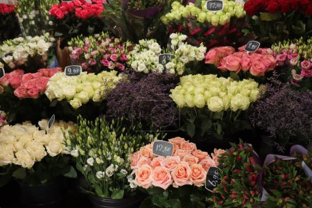 Various shades of fresh roses in a small flower shop. Prices in euros on tags