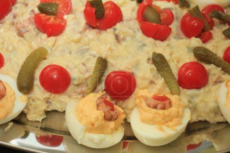 Olivier scrimp salad with pickles, tomatoes and eggs