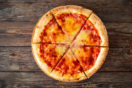 Margherita Pizza with tomato sauce and mozzarella cheese on wooden background 
