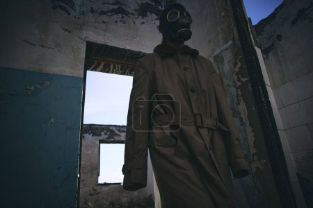 Photo for A man in gas mask walking inside an old building, good for book cover - Royalty Free Image