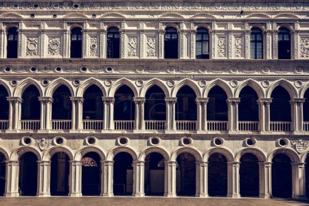 Columns with arches at Palazzo Ducale or Doge's Palace in Venice, Italy. Vintage