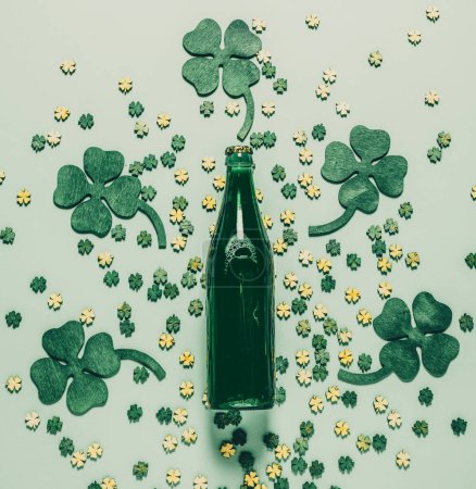 St Patric's Day background with green beer and shamrock. Flat lay