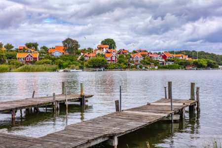 Scandinavian traditional houses and wooden jetty in Karlskrona on Baltic sea coast, Sweden. Brandaholm neighbourhood