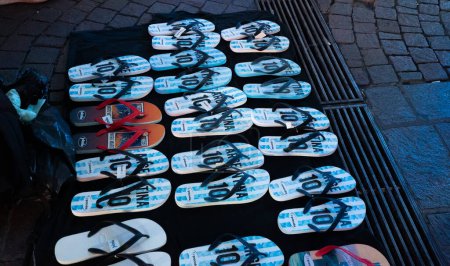 Photo for Buenos Aires, Argentina - 03/12/2022: flip flops in the colors of the national football team in the center of Buenos Aires during the World Cup - Royalty Free Image