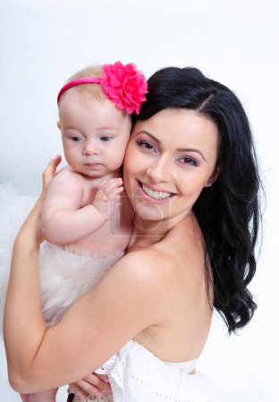 Photo for Happy mother with baby on a light background - Royalty Free Image