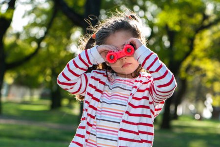 Photo for Child with binoculars in the park - Royalty Free Image