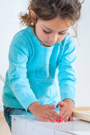 Photo for Little girl in kindergarten at labor lesson - Royalty Free Image
