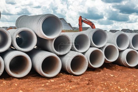 Photo for New concrete pipes stacked on a construction site. Preparation for the manufacture of the sewer system. - Royalty Free Image