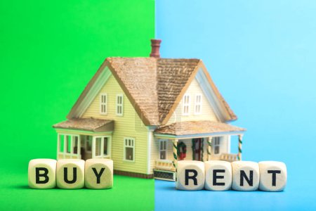 Buy or rent a house. Concept from a house model and wooden cubes.