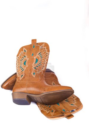 Téléchargez les photos : Women's fashion boots with a pattern. Ladies vintage leather cowboy shoes. Isolated on a white background, close-up. - en image libre de droit