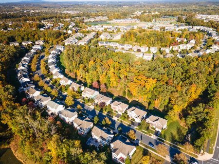 Aerial view of a cluster of houses in a small town in the state of Virginia USA shot by a drone
