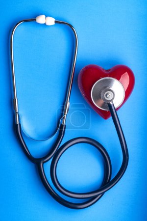 Photo for Medical Stethoscope and red heart on blue background, top view. Space for text. - Royalty Free Image