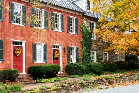 House facades in ancient American city in Virginia with traditional architecture. Ancient brick houses, stone pavements.