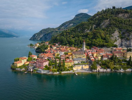 Photo for Flying over colorful houses of Varenna village on Lake Como, Italy. Aerial shot of old town Varenna on the coast of Lake Como. Summer luxury tourism landmark romantic honeymoon travel destination - Royalty Free Image