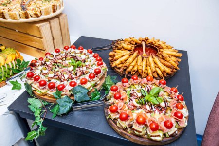Photo for Delicious catering buffet with a variety of gourmet appetizers served at celebration. - Royalty Free Image