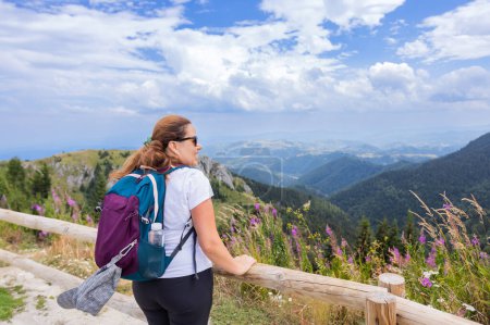 Photo for Woman hiker enjoying summer nature landscape at mountains peak. - Royalty Free Image