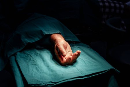 Photo for Patient's hand on operation table ready for surgery in a sterile operating room. - Royalty Free Image