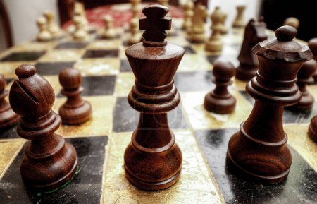 Photo for Close up of black wooden king on vintage chess play board - Royalty Free Image