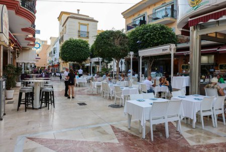 Photo for Torremolinos, Spain - September 9, 2023:Shops, bars, cafes and restaurants in a pedestrian precinct in La Carihuela, Torremolinos, Costa Del Sol, Spain - Royalty Free Image
