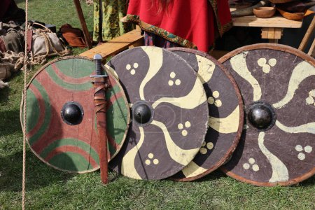 Medieval weapons, shields in knight camp at the festival of historical reconstruction