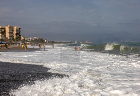 Photo for Torremolinos, Spain - September 14, 2023:  Foamy sea waves on the sandy beach of Bajondillo in Torremolinos, Malaga, Costa del Sol, Spain - Royalty Free Image