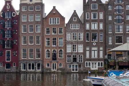 Photo for Amsterdam, Netherlands - April 21, 2023: Typical gabled houses on Damrak district in  Amsterdam, Netherlands - Royalty Free Image