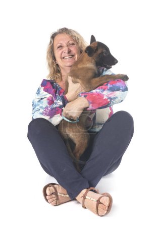 Photo for Puppy belgian shepherd and woman in front of white background - Royalty Free Image