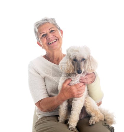 Photo for Senior woman and dog in front of white background - Royalty Free Image