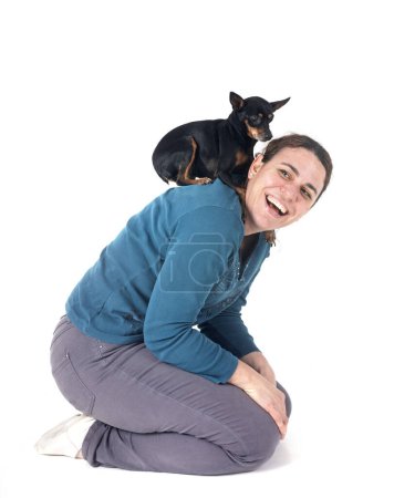 Photo for Miniature pinscher and woman in front of white background - Royalty Free Image