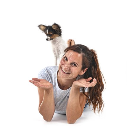 Photo for Papillon dog and woman in front of white background - Royalty Free Image