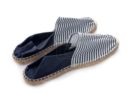 blue and white espadrilles in front of white background