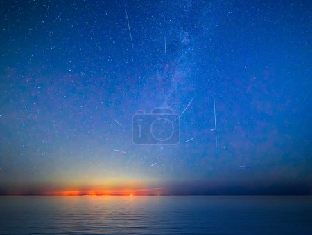Photo for Milky Way and Perseid Shower 2023 over Sicily - shot from Malta. Beautiful night sky with Milky Way and the coastal lights of Sicily as seen from Malta - Royalty Free Image