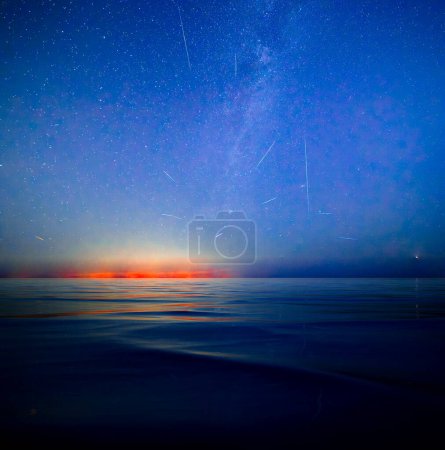 Photo for Milky Way and Perseid Shower 2023 over Sicily - shot from Malta. Beautiful night sky with Milky Way and the coastal lights of Sicily as seen from Malta - Royalty Free Image